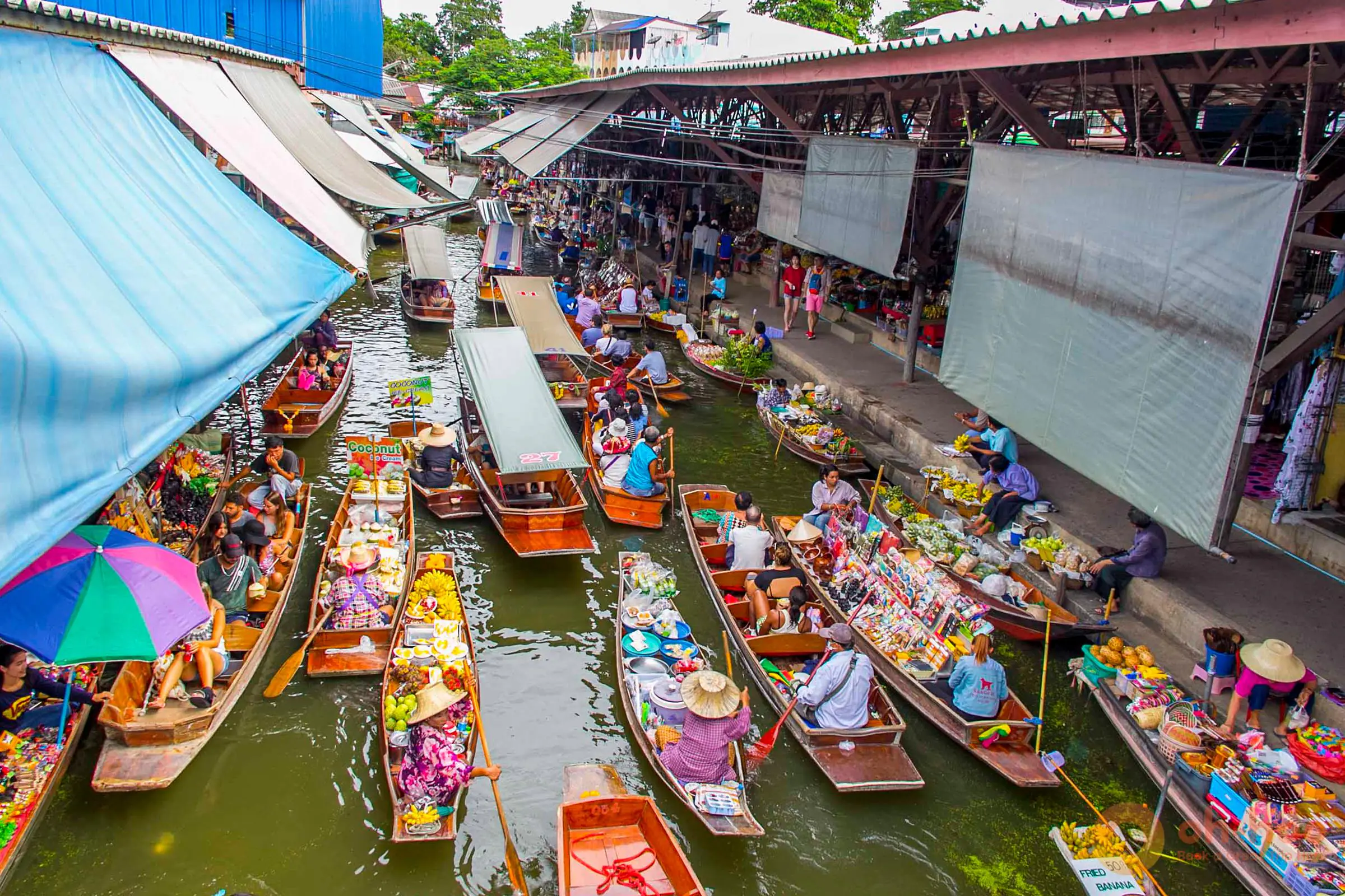 Vendor boats loaded with fruit on the canal at Damnoen Saduak Floating Market in the early morning