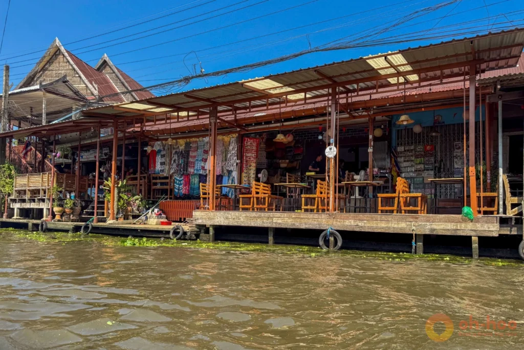 Wooden walkway and stalls beside the canal at Damnoen Saduak Floating Market