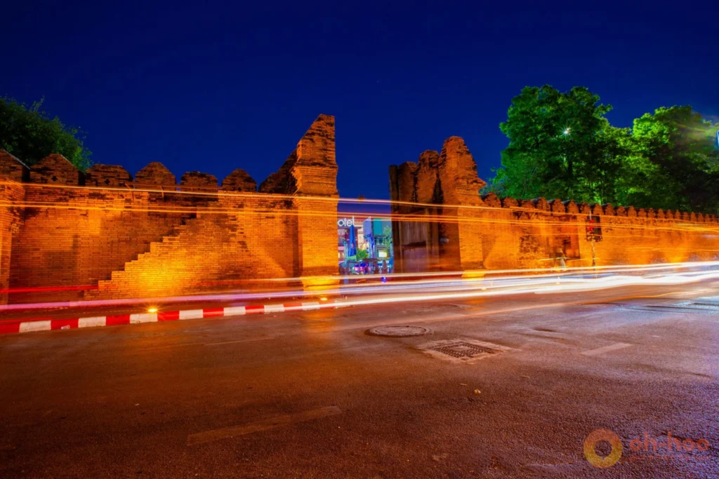Moat and old city wall in Chiang Mai at dusk with traffic and lanterns