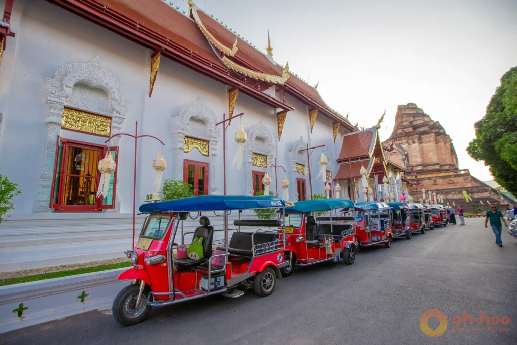 Tuk tuk parked outside an ornate temple gate in Chiang Mai's old city