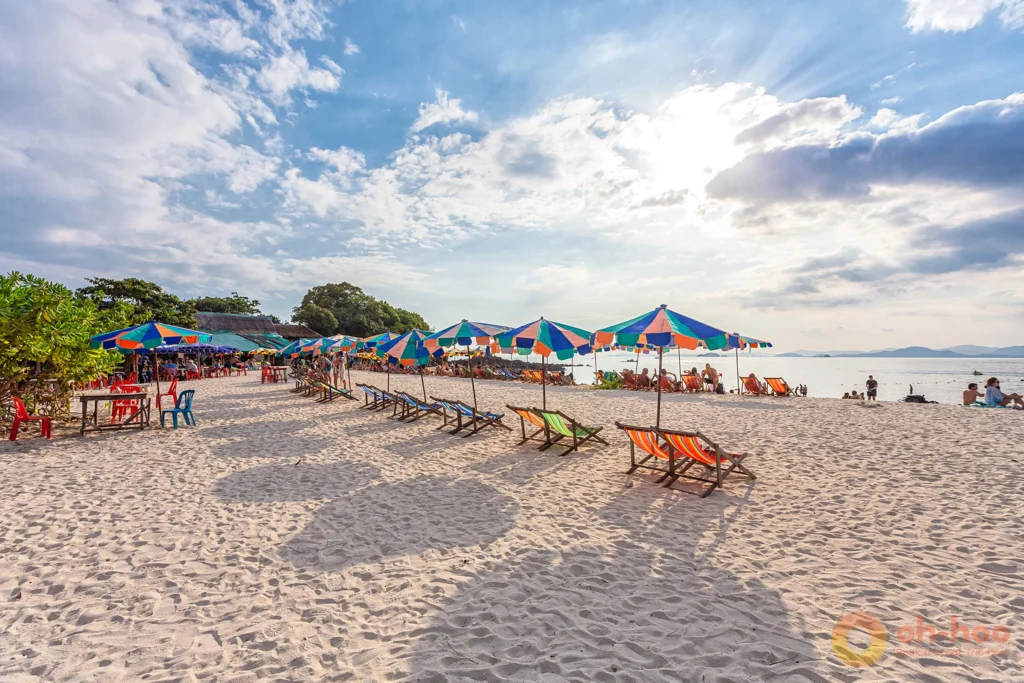 Beach restaurant tables and umbrellas under the trees on a Khai island beach