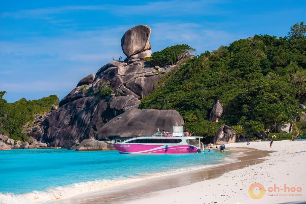 Speedboat moored off a white sand beach at the Similan Islands on a clear day