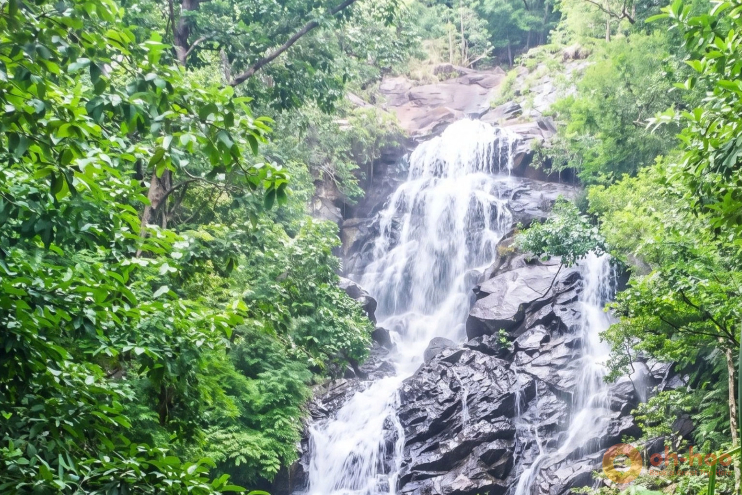 Water running over granite boulders into a clear pool at a Koh Phangan jungle waterfall