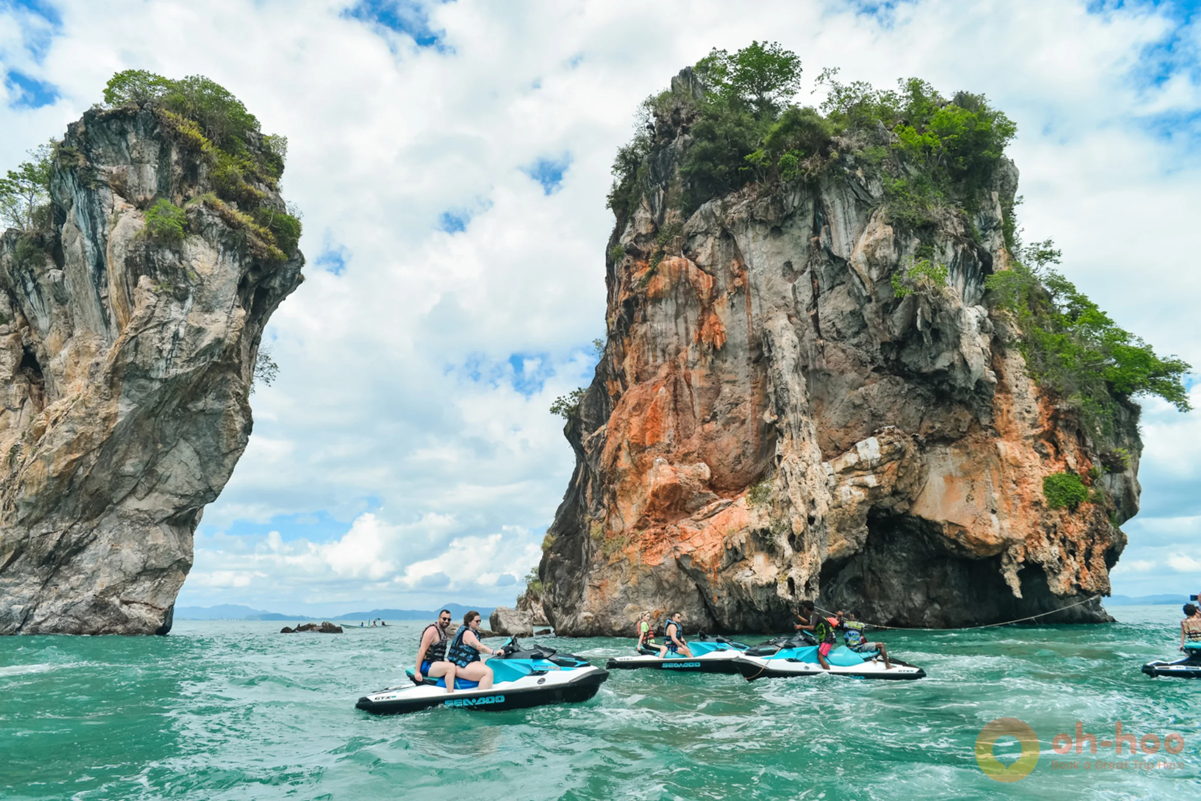 Jet ski cutting across clear blue water off a Phuket beach on a sunny day