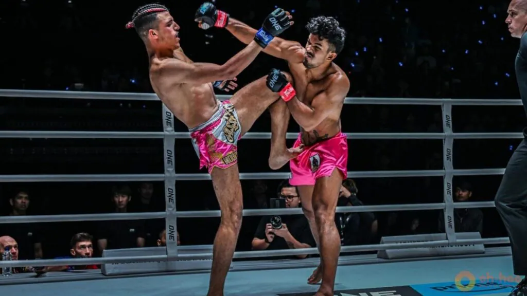 Two fighters exchange strikes inside a ring during an event at Lumpinee Stadium in muay thai bangkok.