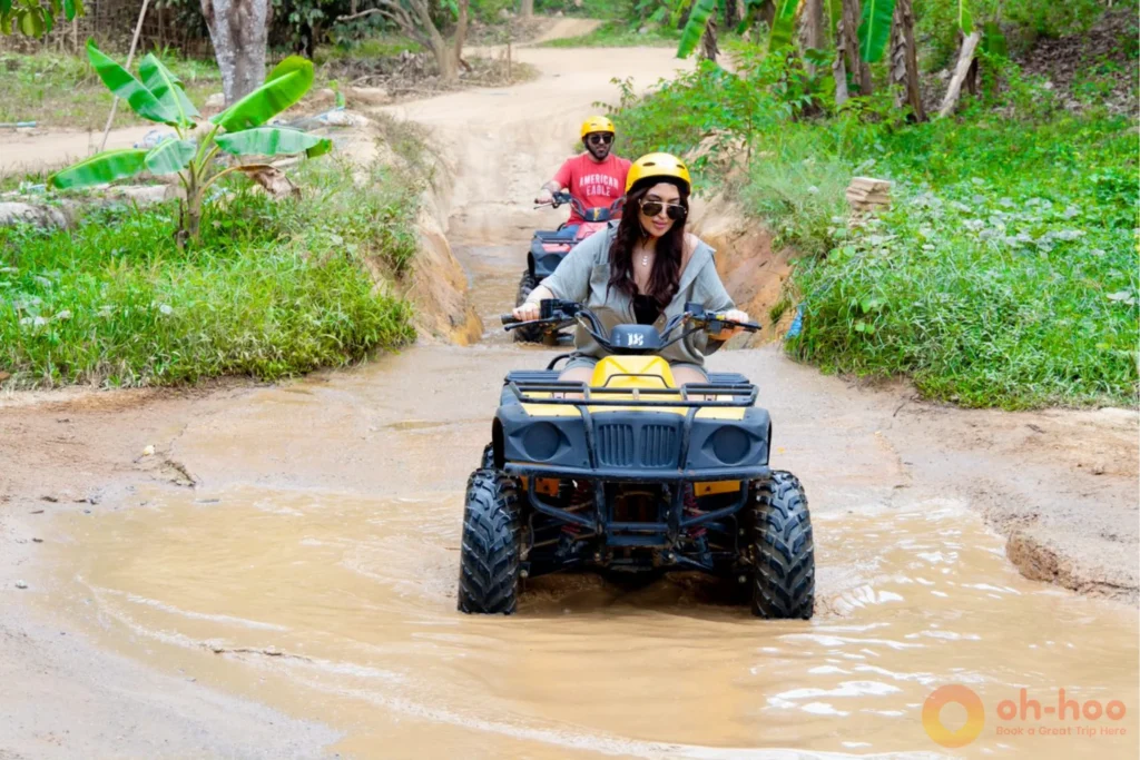 Quad bikes on a jungle trail in Phuket with the Big Buddha on the hill beyondf