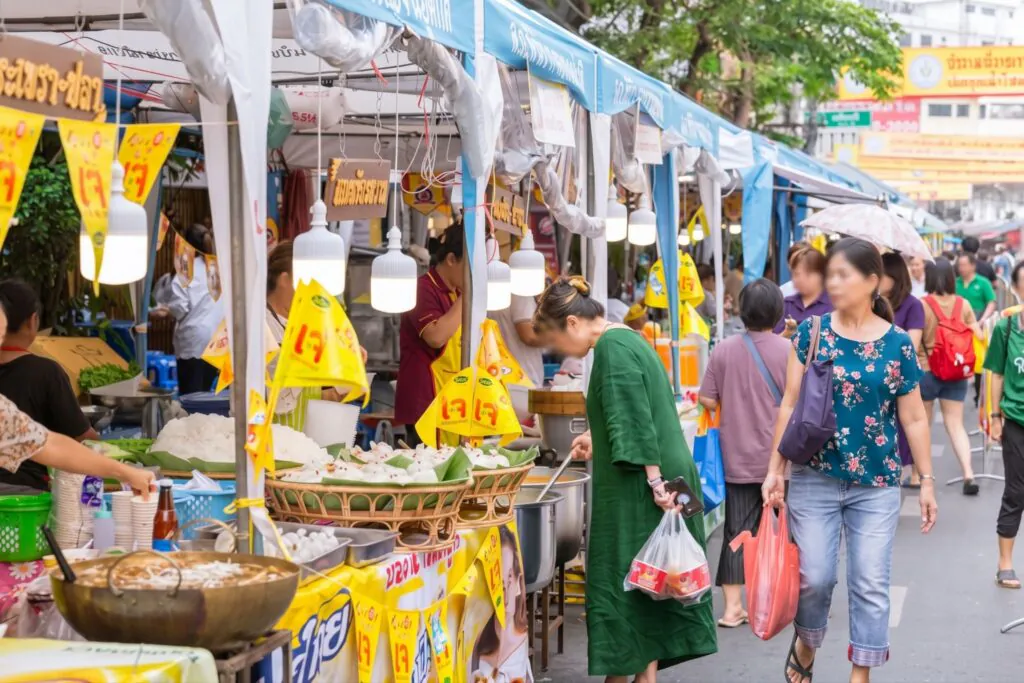 Jay vegetarian street food stalls lit up along Yaowarat Road in Bangkok Chinatown