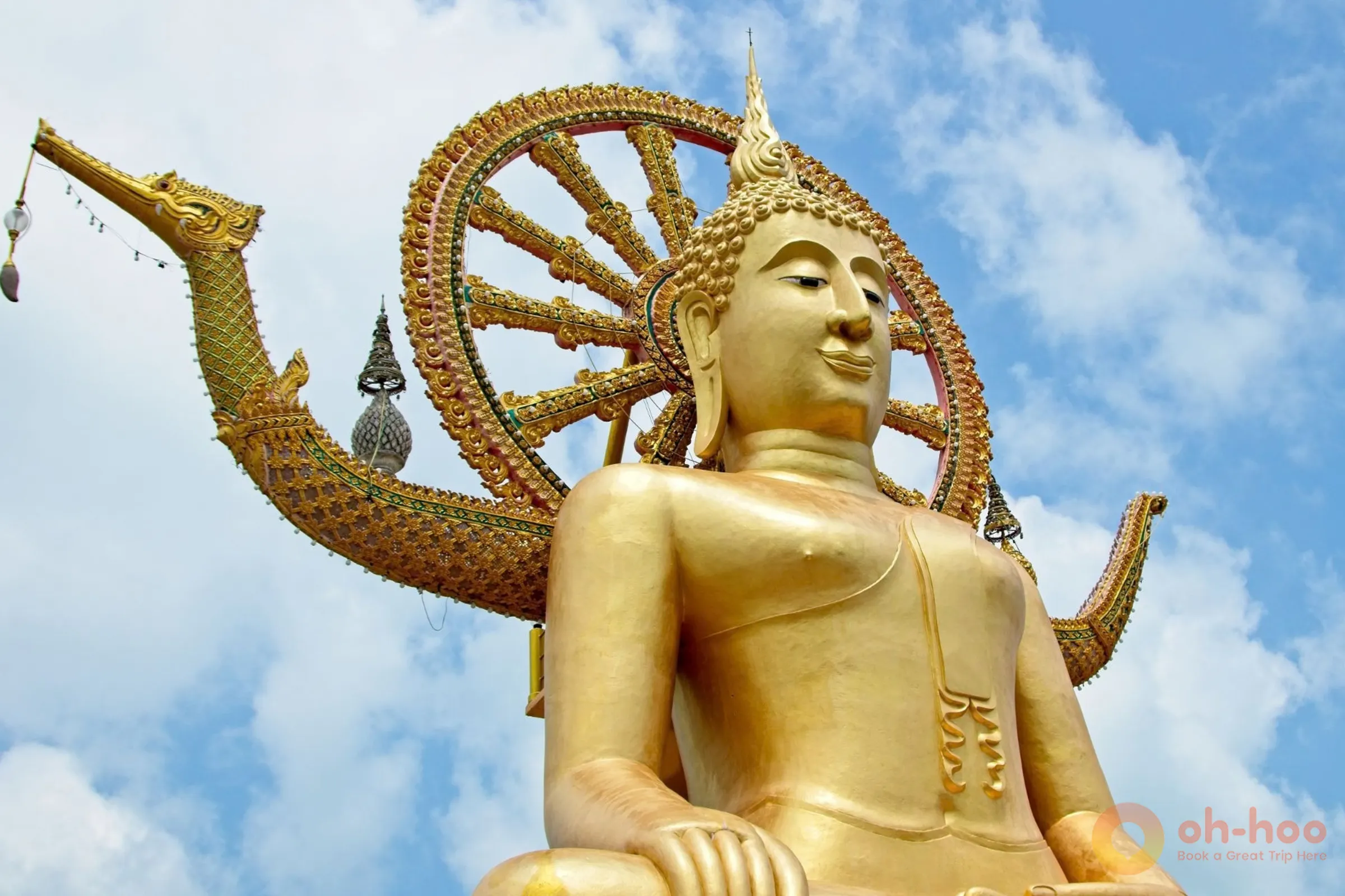 Golden Big Buddha statue against a clear blue sky at Wat Phra Yai in Koh Samui