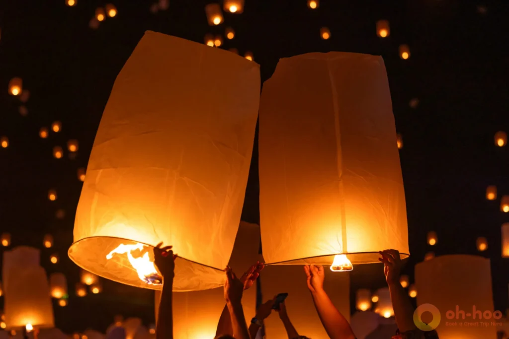 Thousands of sky lanterns floating into the night sky during Yi Peng Festival in Chiang Mai