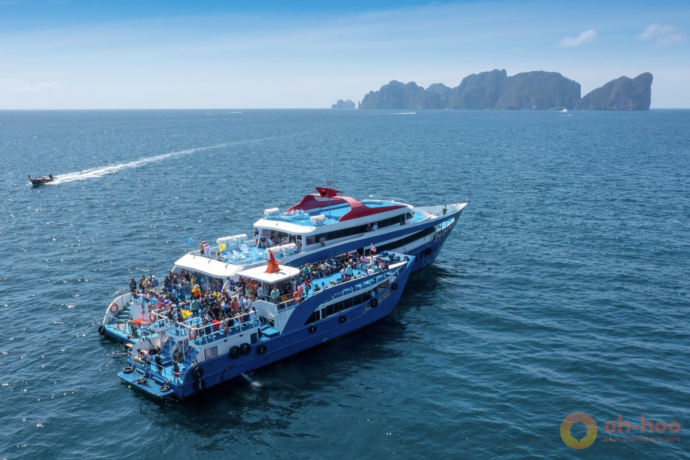 Large passenger ferry cruising peacefully across calm blue Andaman sea from Phuket to Koh Phi Phi